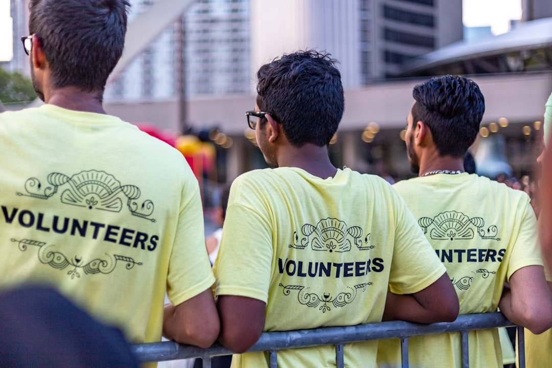 Volunteers in matching shirts gathered together at a community event