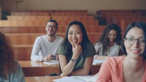 Students smiling together in a lecture hall, the audience that fun presentation topics are picked for
