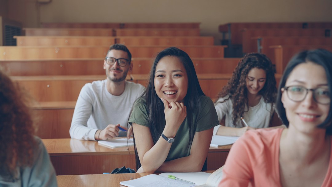 Students smiling together in a lecture hall, the audience that fun presentation topics are picked for