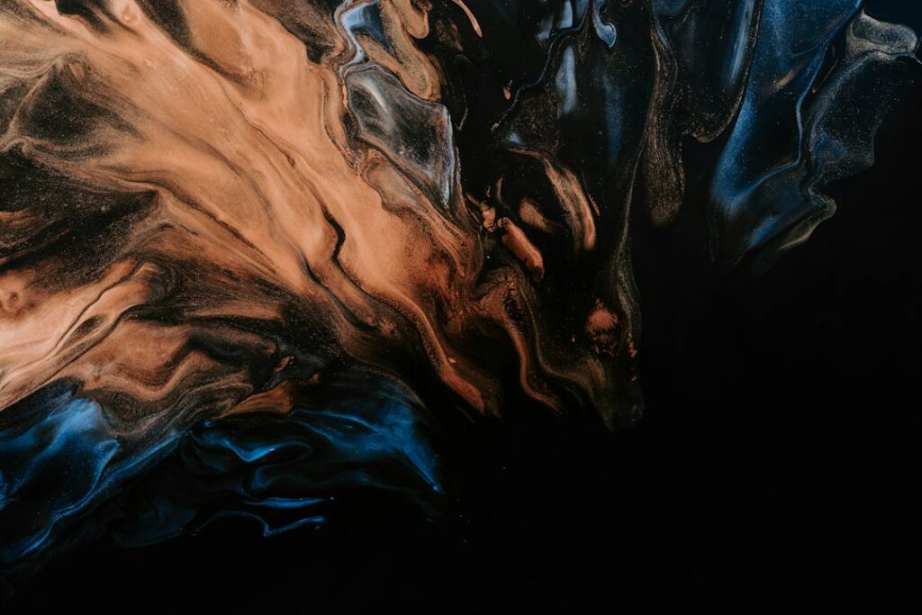 Abstract swirl of dark, tan and blue paint, a reminder that strong contrast makes a good PowerPoint presentation readable